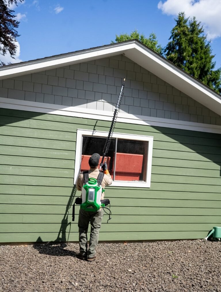 Pest Near technician treating a wasp nest on a home