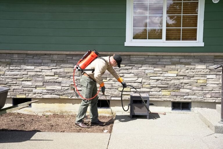 Pest Near technician applying exterior ant treatment around an Everett WA home