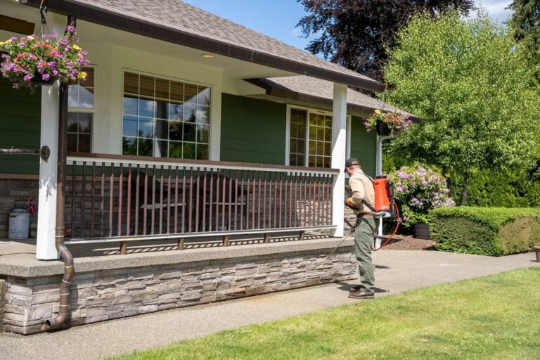 Pest Near technician applying exterior ant treatment around an Everett WA home